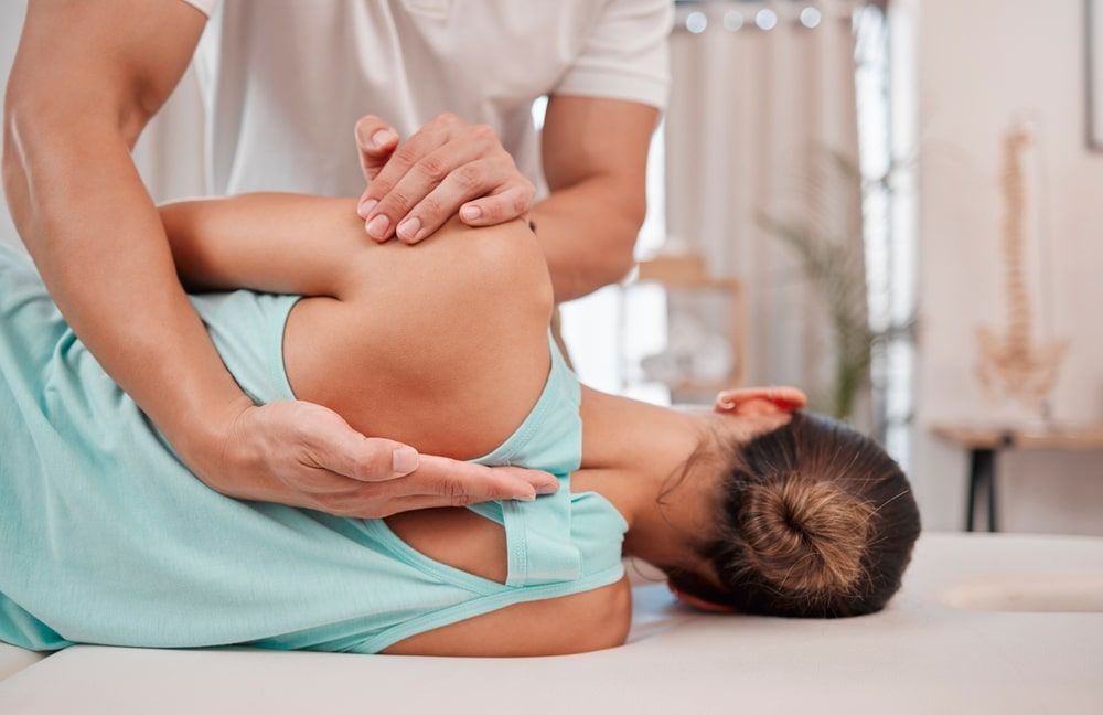 chiropractor helping woman with spine alignment