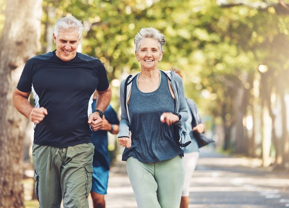 Happy elderly couple doing outdoor workout