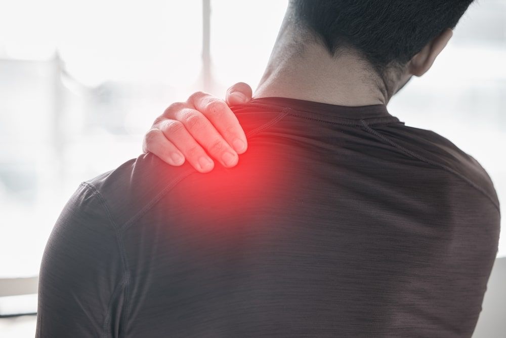 man suffering from back pain and injury on the shoulder