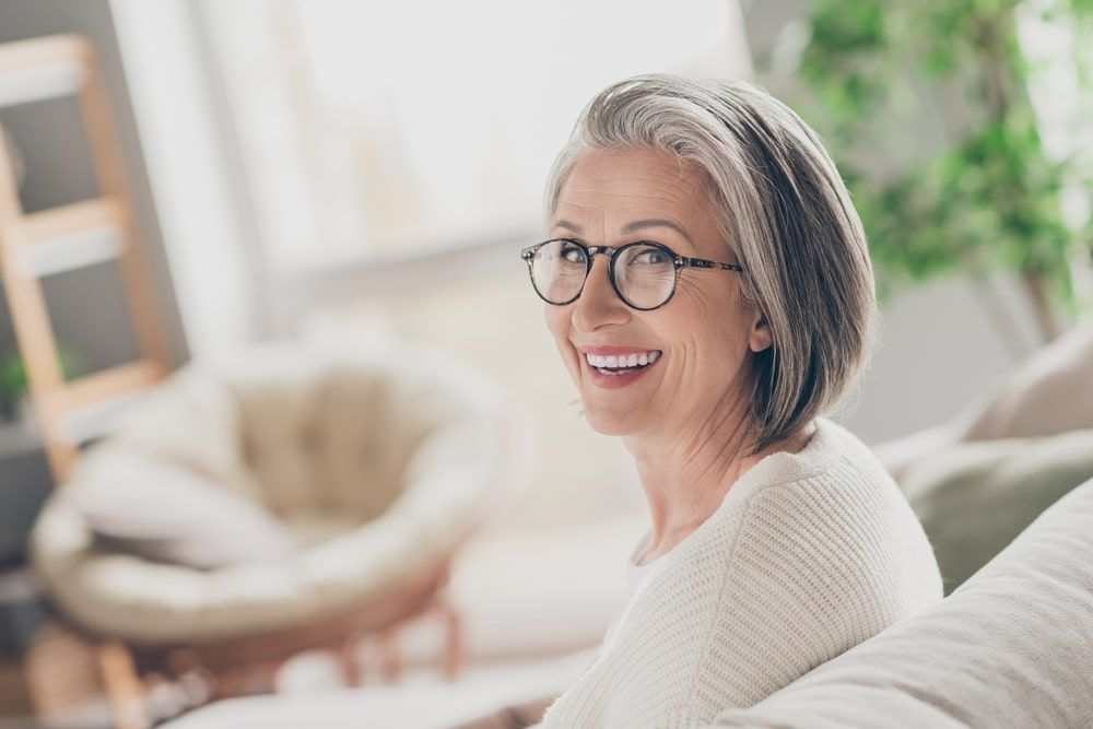 charming good mood elderly lady wear white cardigan spectacles smiling