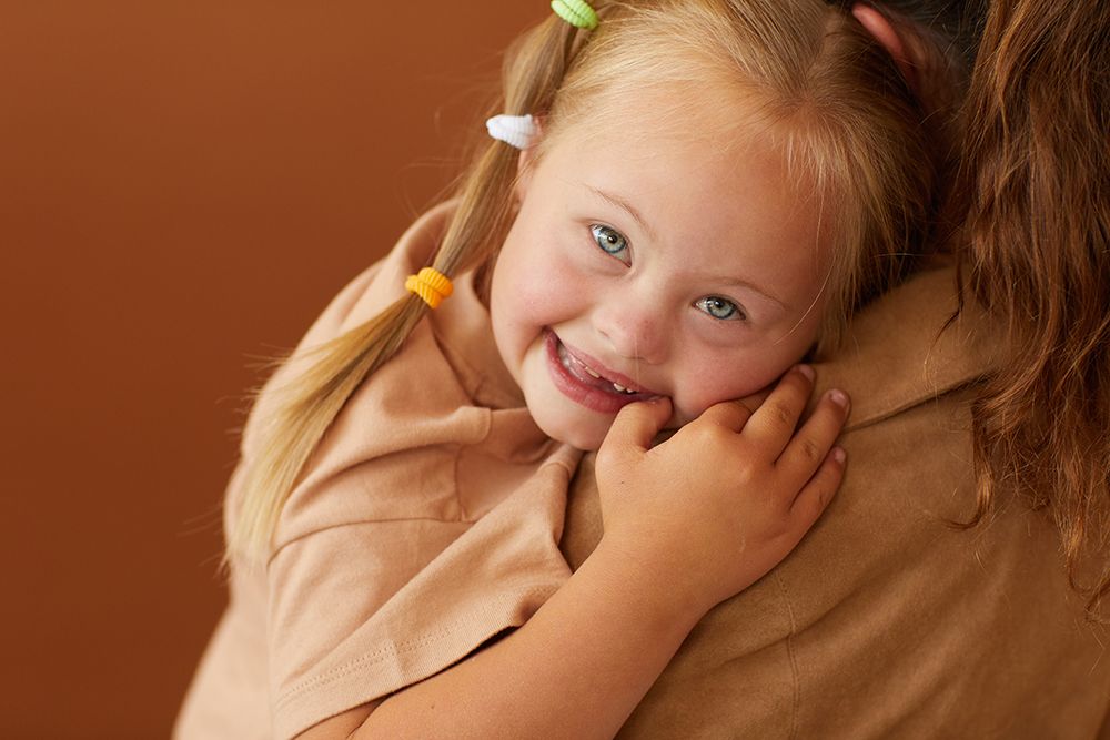 Mother holding happy daughter