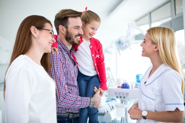 Family visits dentist in dental office for first time together