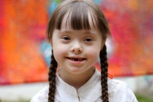 Portrait of little girl smiling on background of the colorful wall