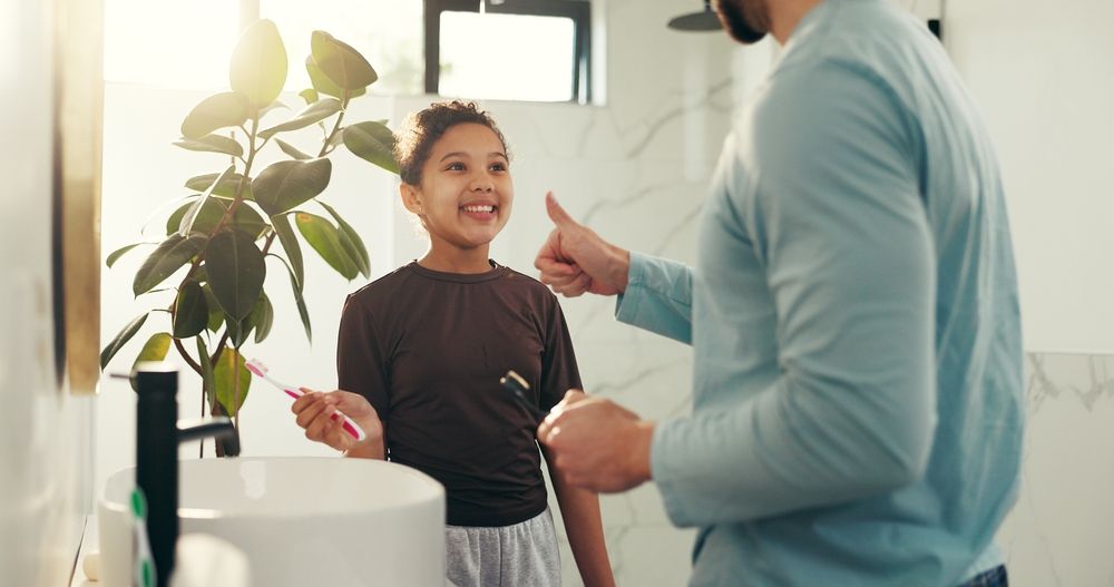 Child, father and brushing teeth with thumbs up in bathroom