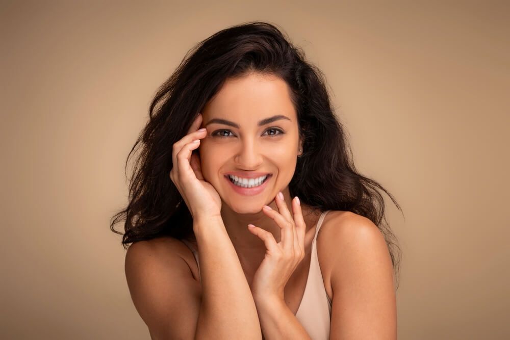 girl smiling after Collagen Builder (Sculptra)