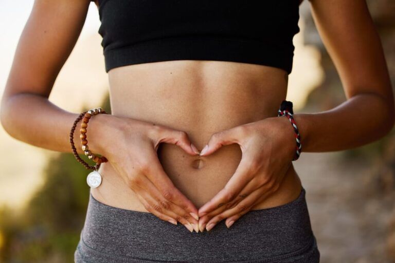 Woman, with hands on stomach with heart shaped