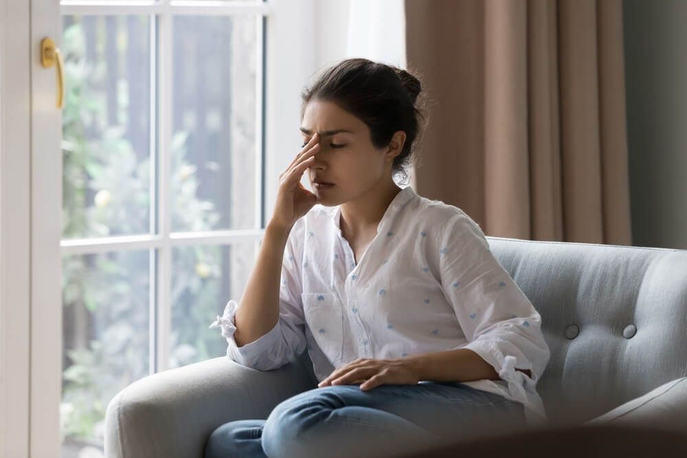 Depressed young woman suffering from headache