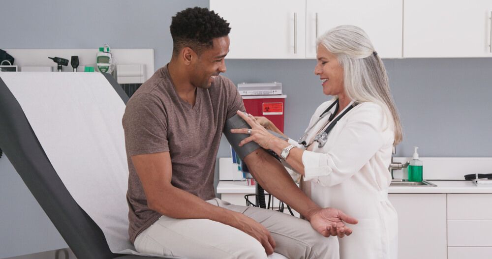 physician performing comprehensive adult wellness exam