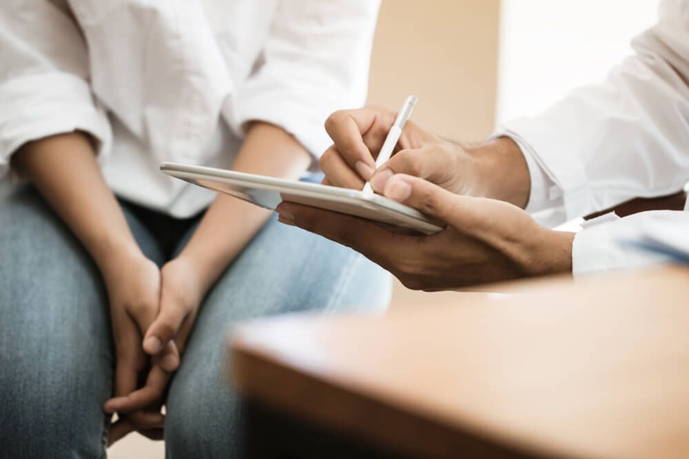 physician conducting pre-operative evaluation