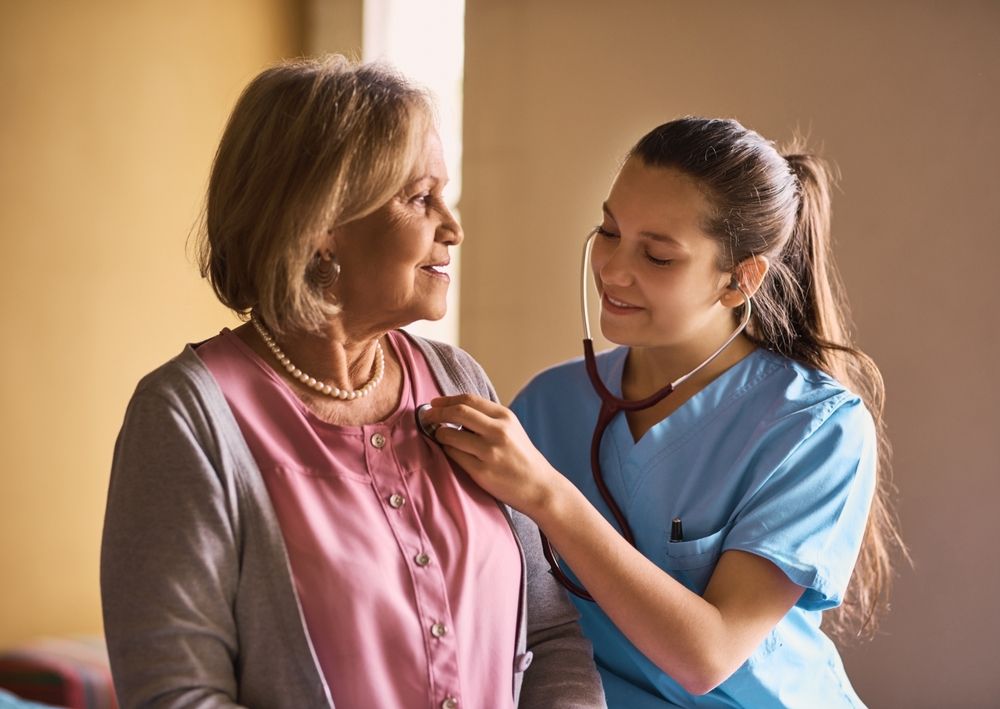 Senior woman, nurse and stethoscope to listen to heart beat, check up or cardiology exam