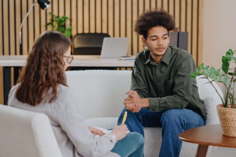 young man in consultation with psychologist is taking care of mental health. Psychotherapy for treatment of disorders and depression
