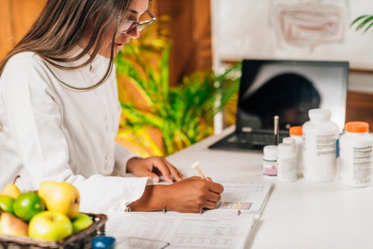 Functional medicine doctor taking notes for personal health report