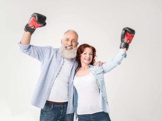 Happy mature couple in boxing gloves