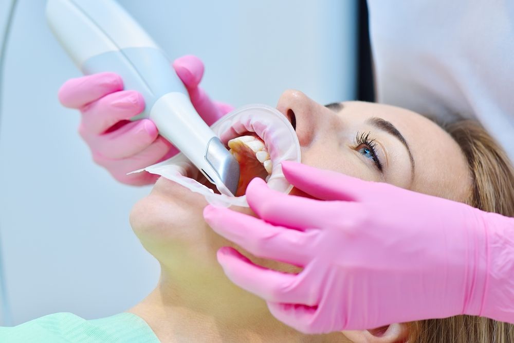 Woman,Dentist,Using,Dental,Intraoral,Scanner,While,Examining,Patient,Teeth