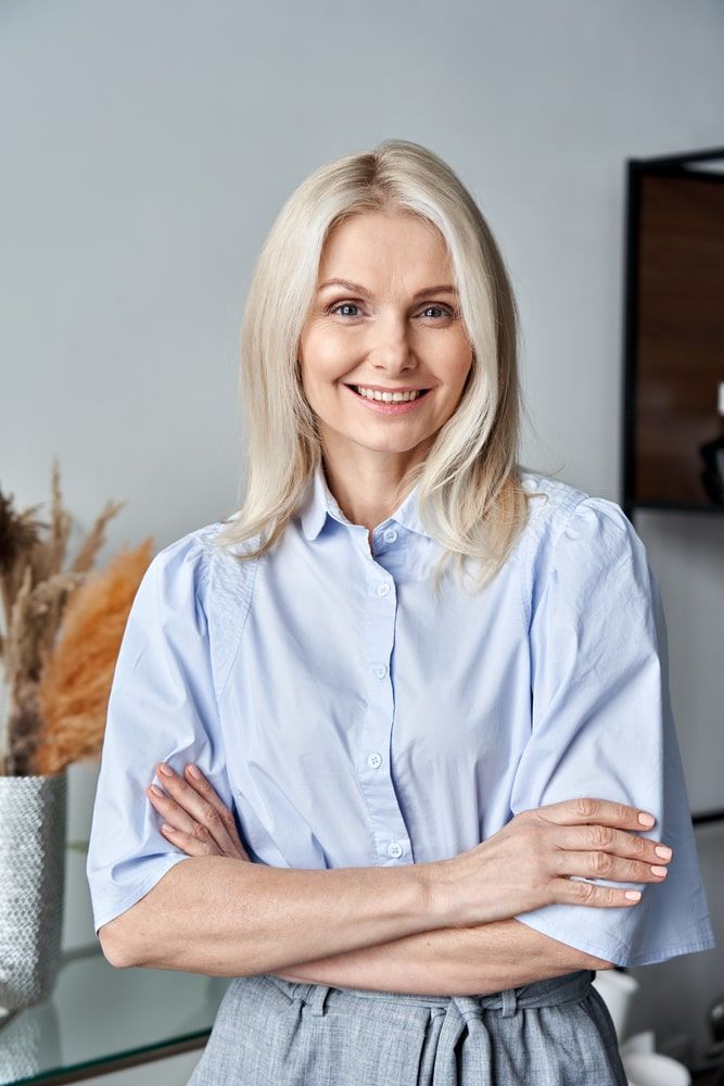 Smiling confident middle aged woman standing