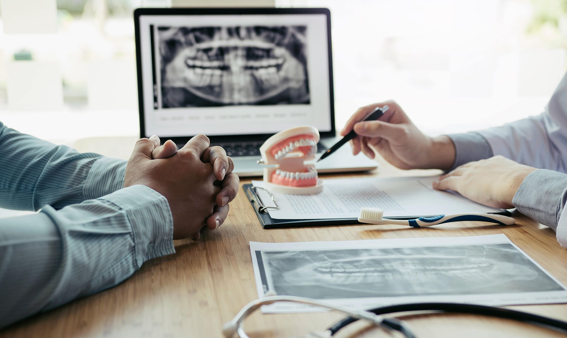 Dentists are discussing dental problems at report x-ray image