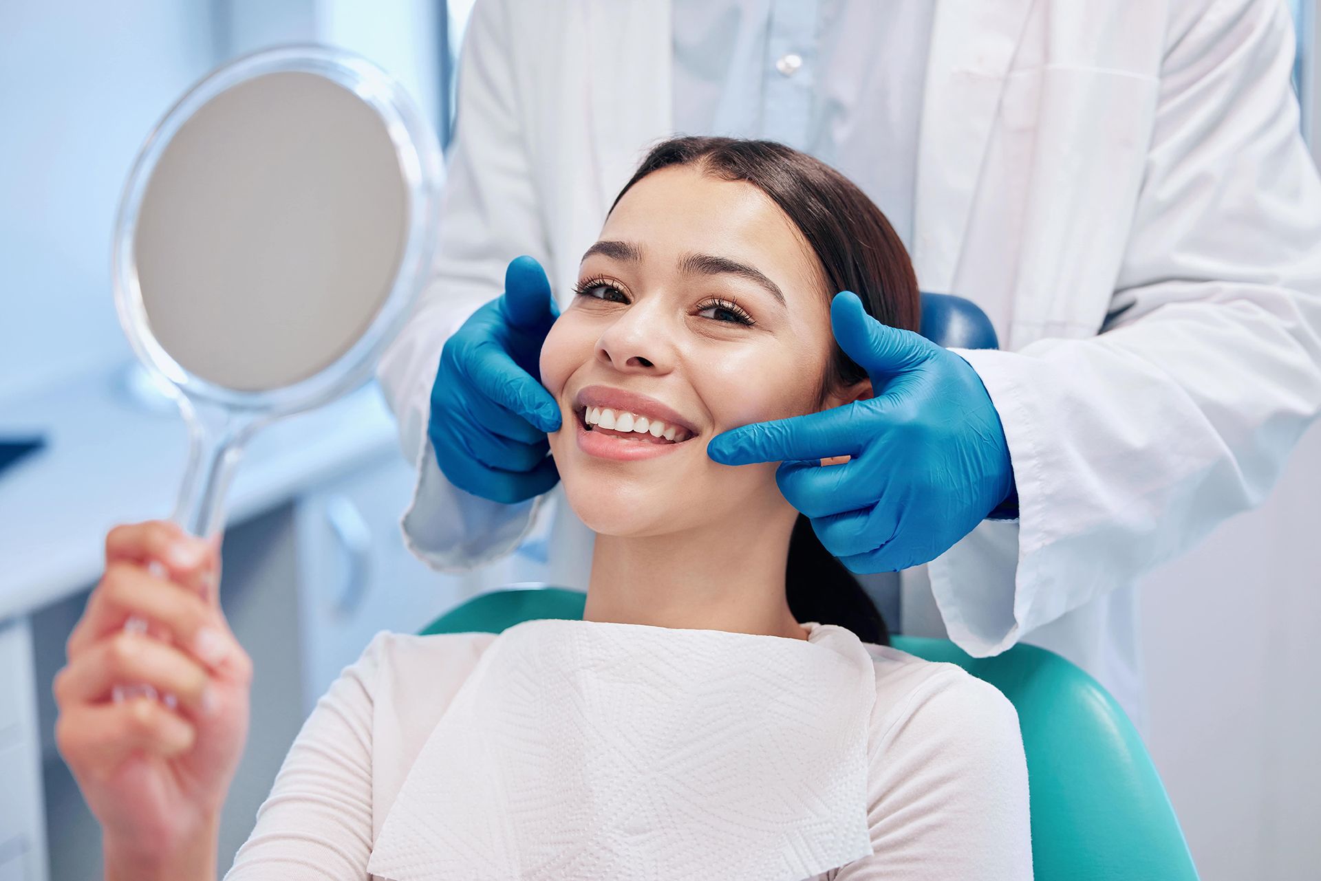 Young woman checking her results in the dentists office