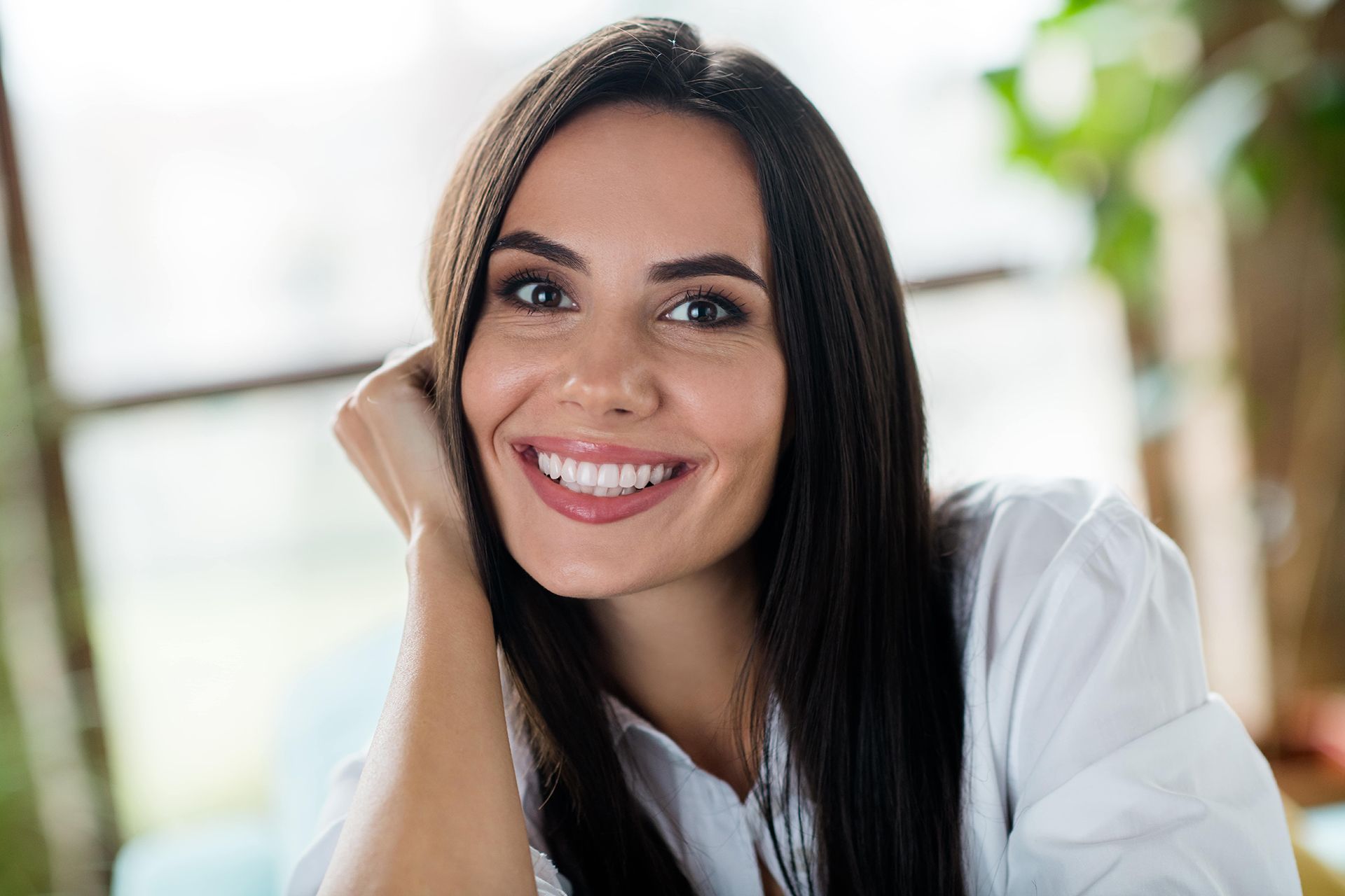 Cheerful girl beaming smile arm touch cheekbone