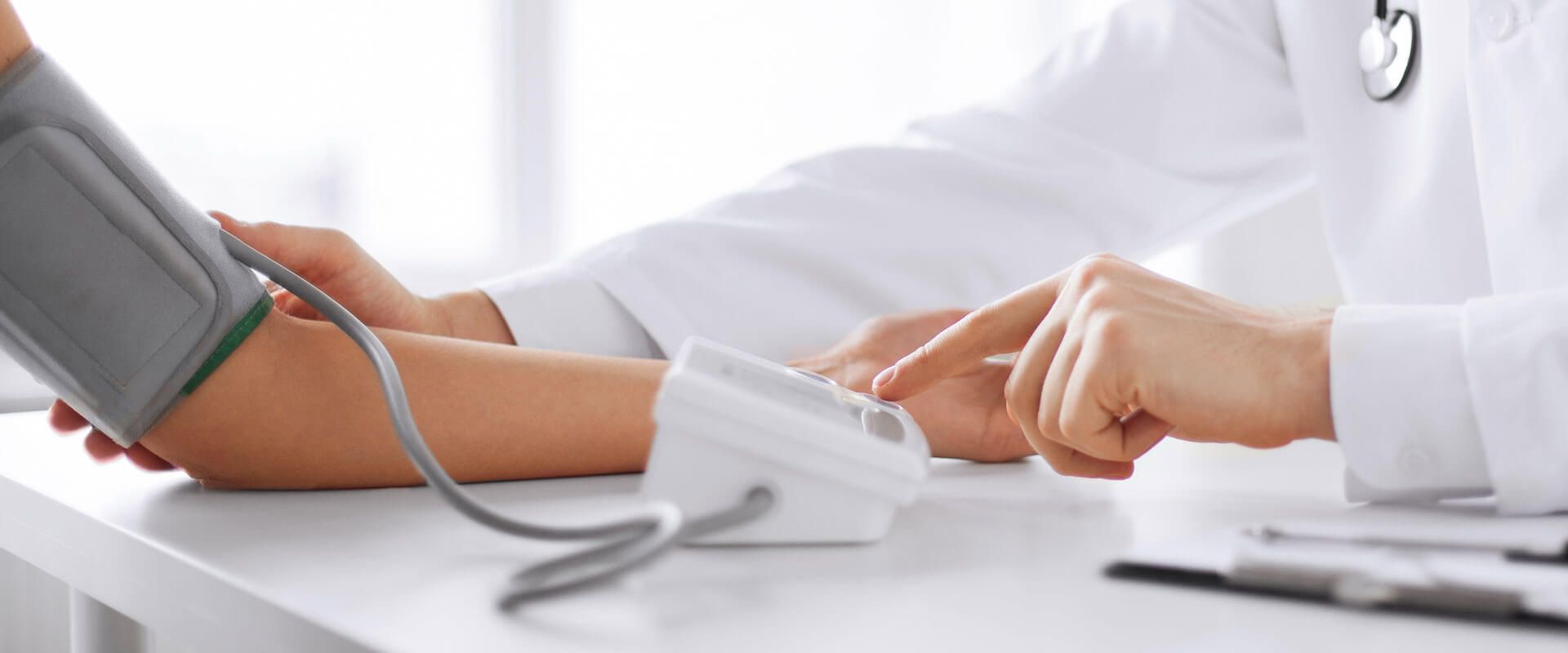 Doctor measuring blood pressure of patient