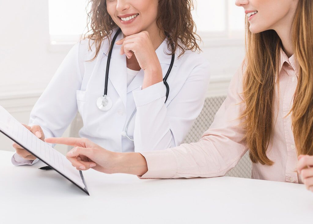 Young woman planning diet plan with nutritionist