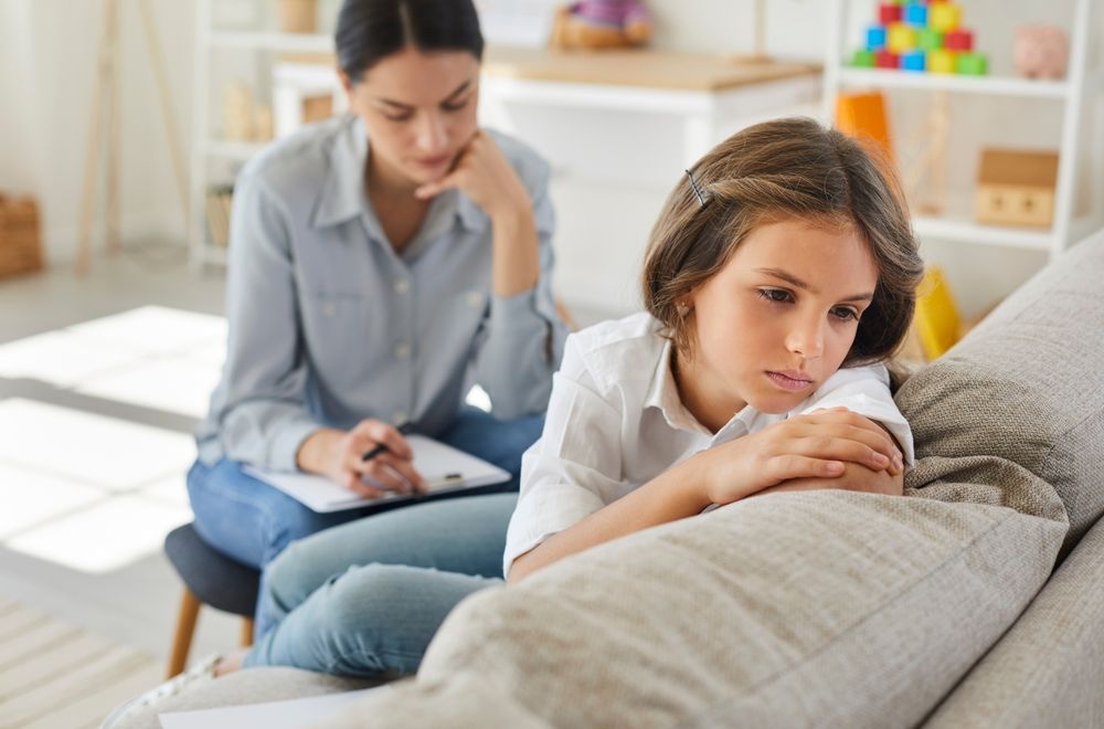 A child with a therapist in need of Children & Teen therapy assistance