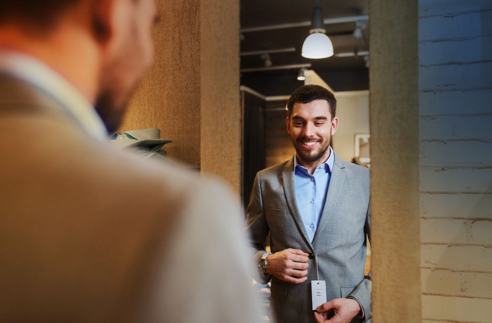 Man smiling in the mirror working on his Self-Esteem