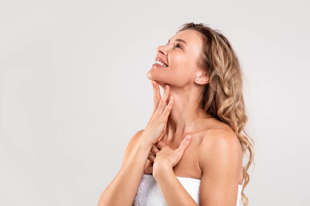 Beautiful Middle Aged Woman Touching Soft Smooth Skin On Neck