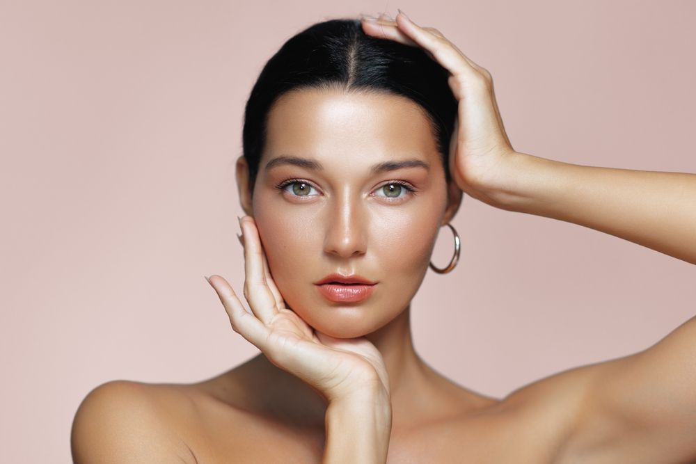 Close-up studio portrait of a beautiful Latina woman with radiant skin and soft makeup