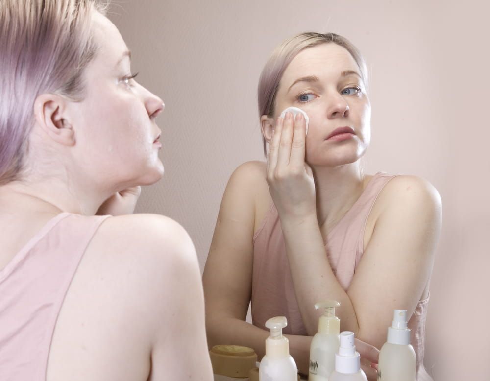 The girl in the mirror. Aging of the skin. The wrinkle cream. Anti-aging cosmetics