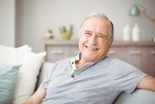 Happy senior man smiling at home