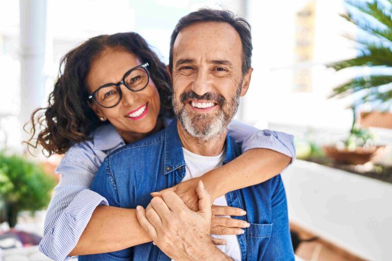 Middle age couple smiling confident hugging each other