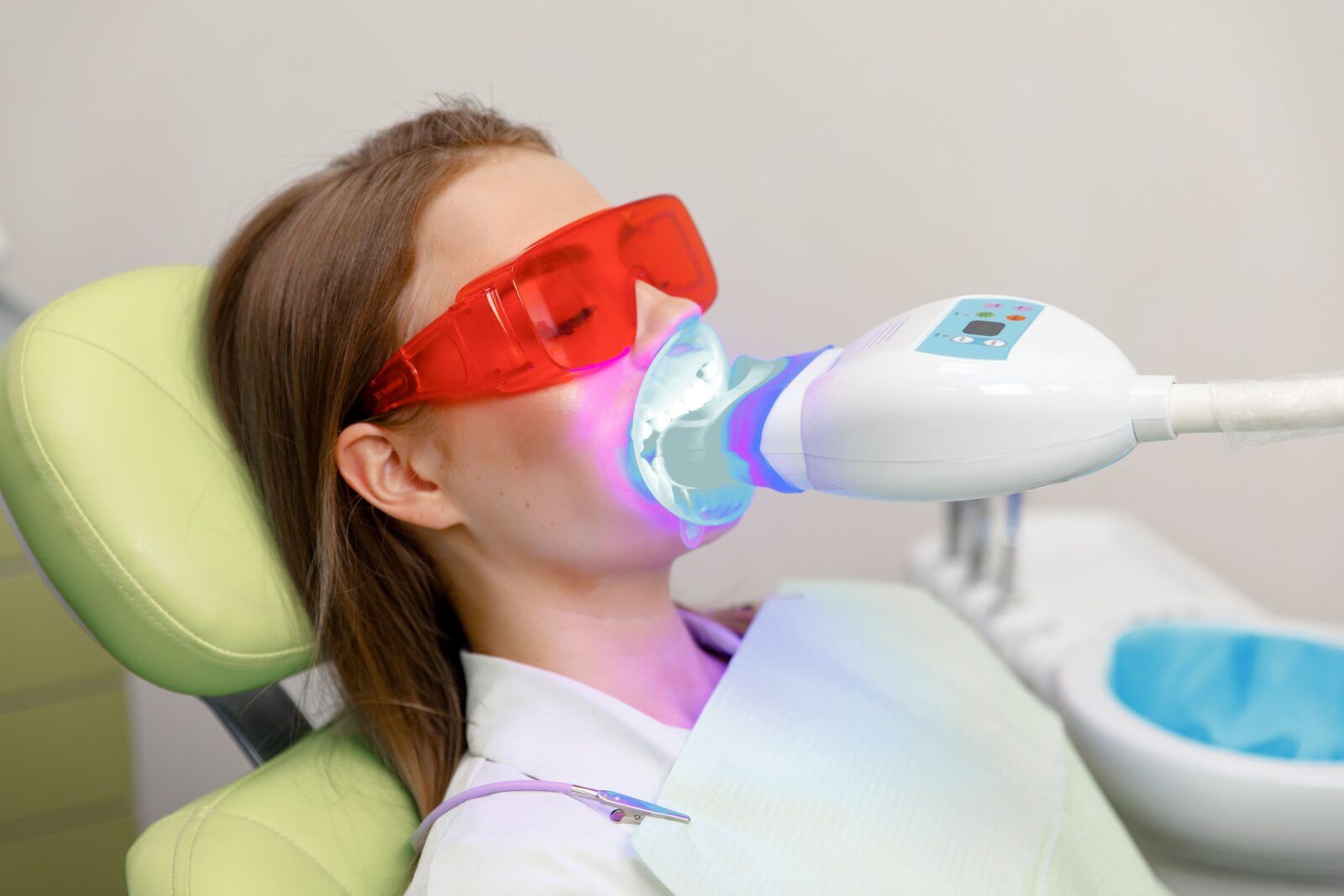 Woman receiving teeth cleaning at dental clinic