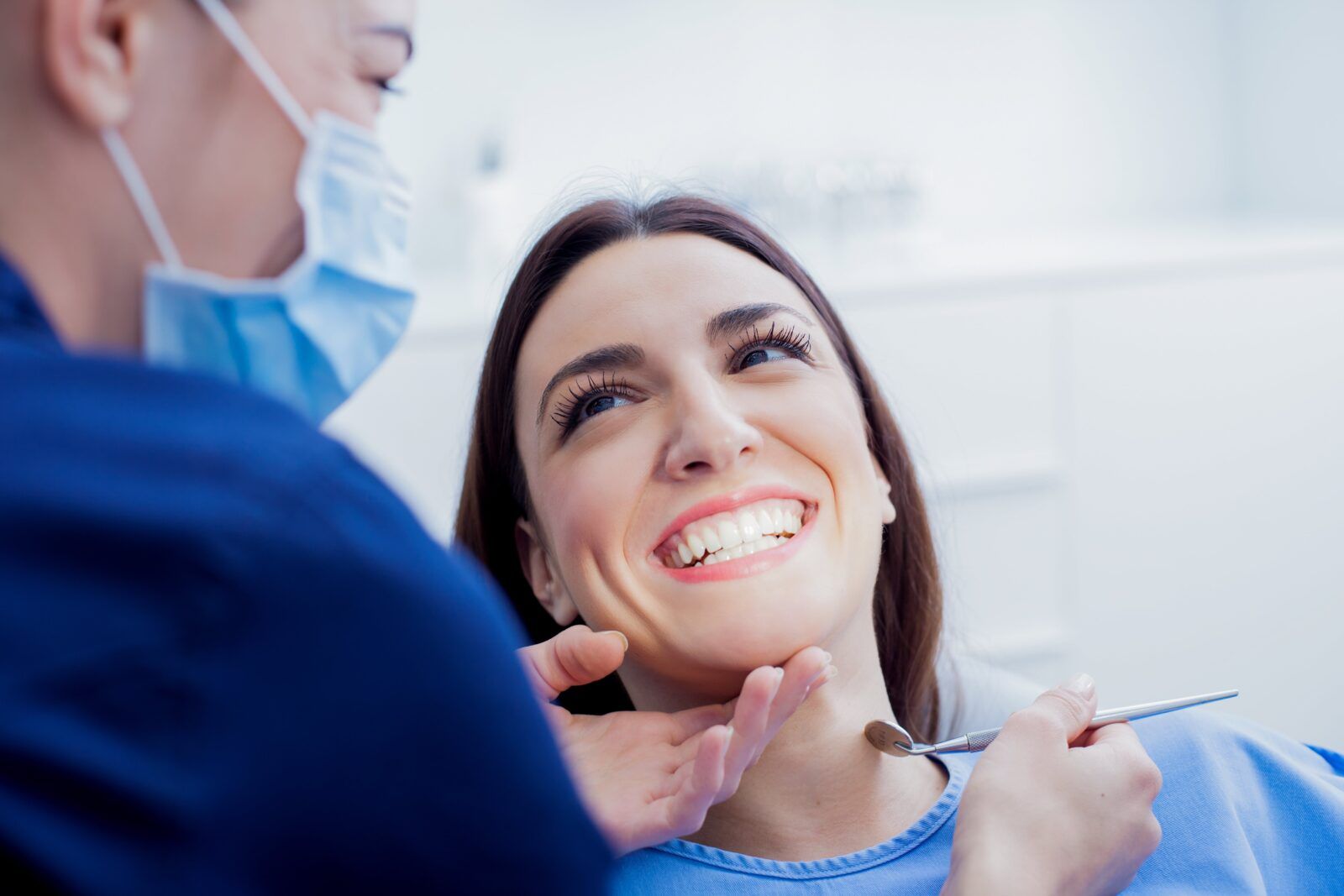 Happy woman getting dental treatment