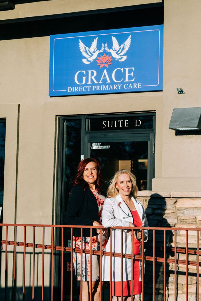 Tammy Frost and a colleague standing outside Grace Direct Primary Care office entrance