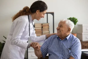 Primary care doctor providing home visit a senior patient discussing family medicine options
