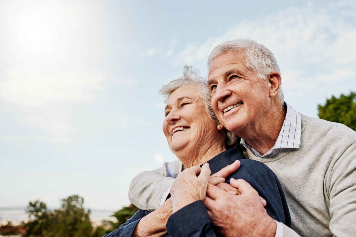 Happy elderly couple and hug outdoors