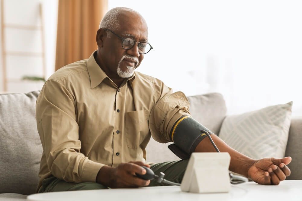 Senior Man Measuring Arterial Blood Pressure Having Problems With Tension