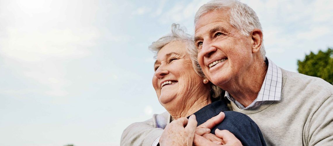 Happy elderly couple and hug outdoors