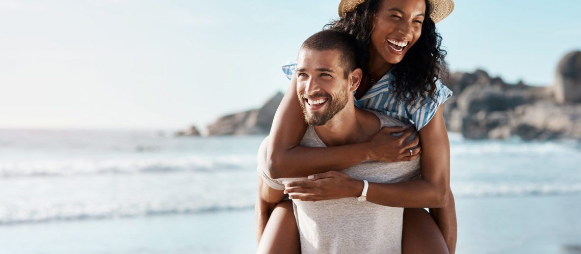 happy couple enjoying at beach