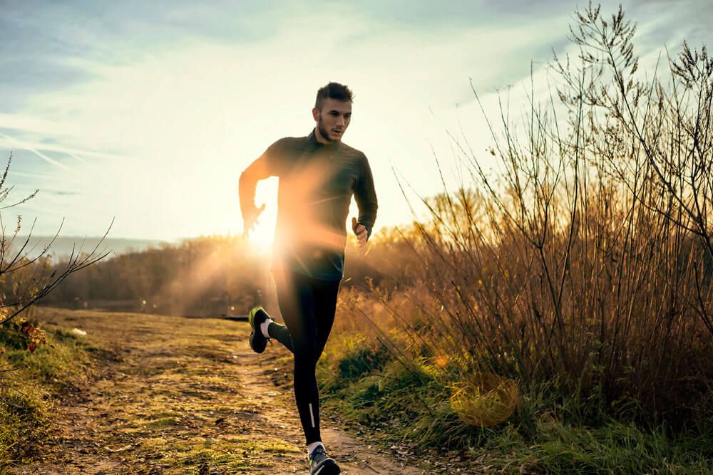 man running in sun set