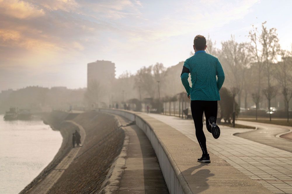 Young fitness man running in urban area