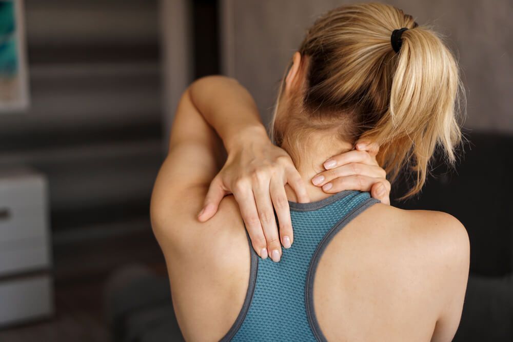 An athletic girl experiencing neck pain