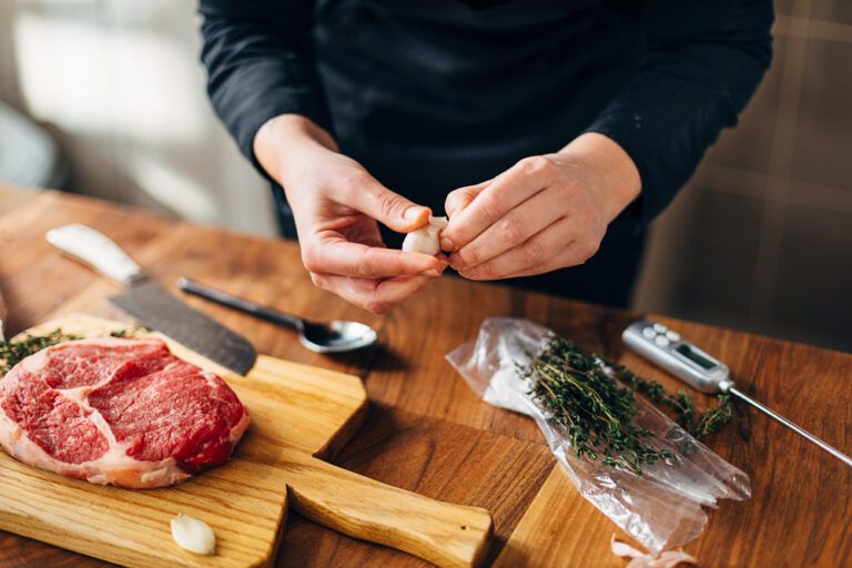 Overhead shot of chef preparing ribeye in a kitchen