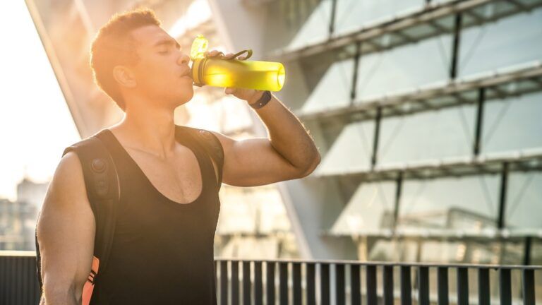 Workout, hydration bottle and thirsty athlete outdoor for wellness