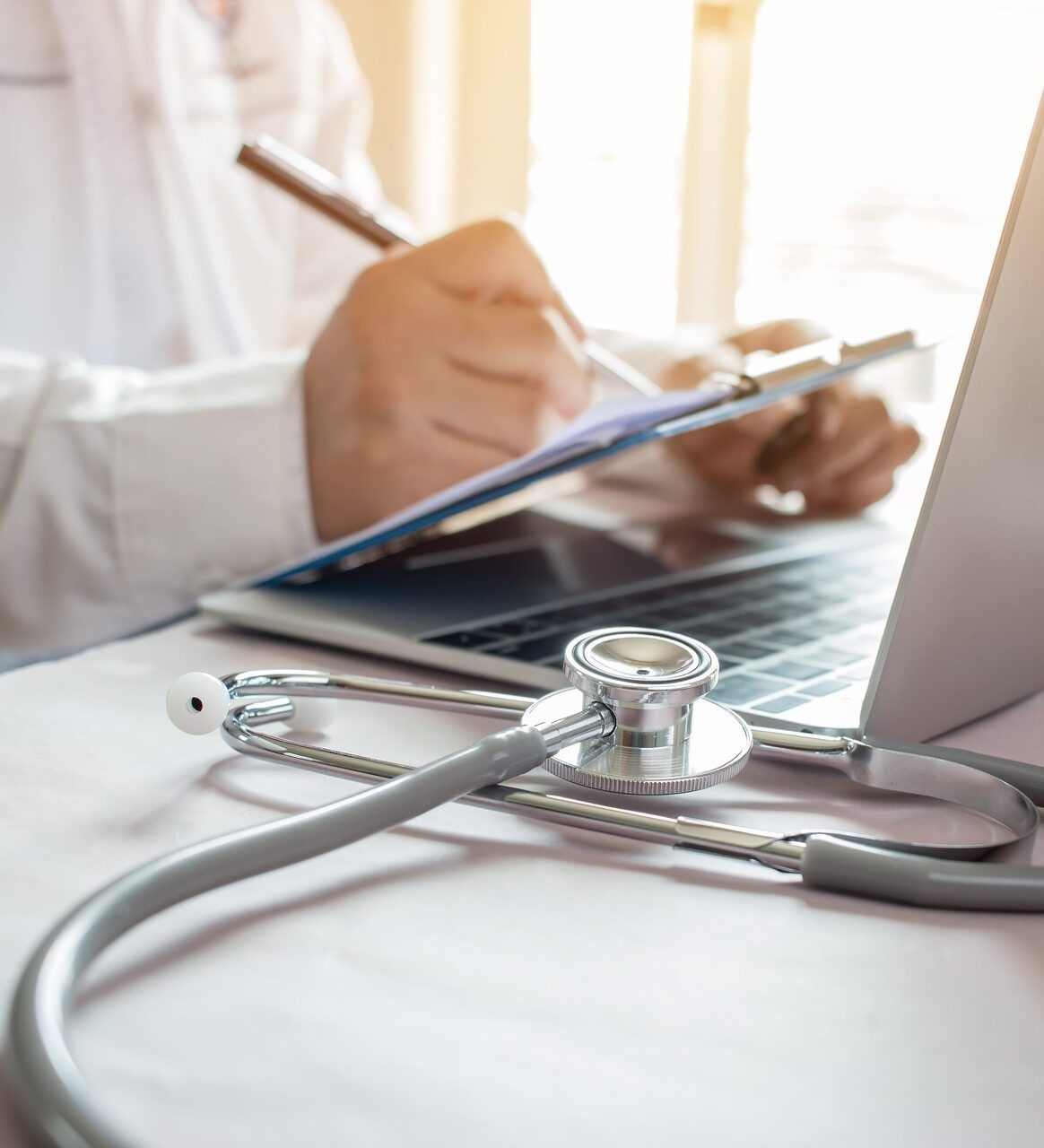 Medicine doctor's writing on laptop in medical office.Focus