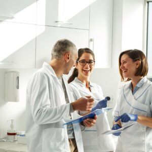 Medical dentist team in dental office examining list of patients