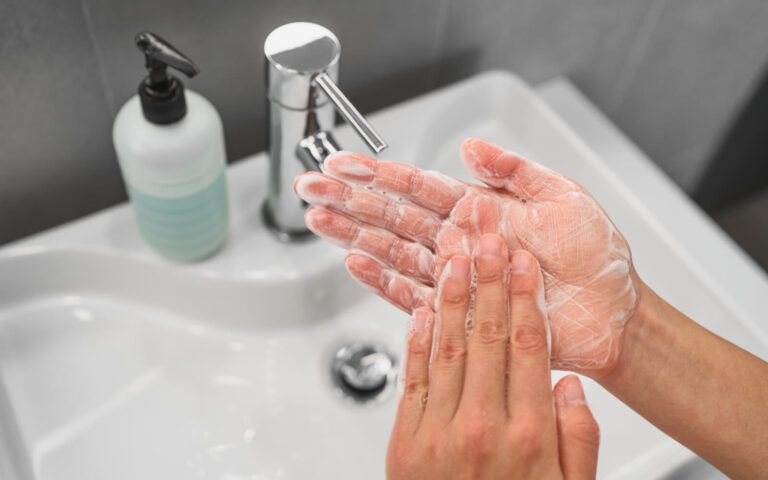 Washing hands rubbing soap in palm lathering up foam bubbles
