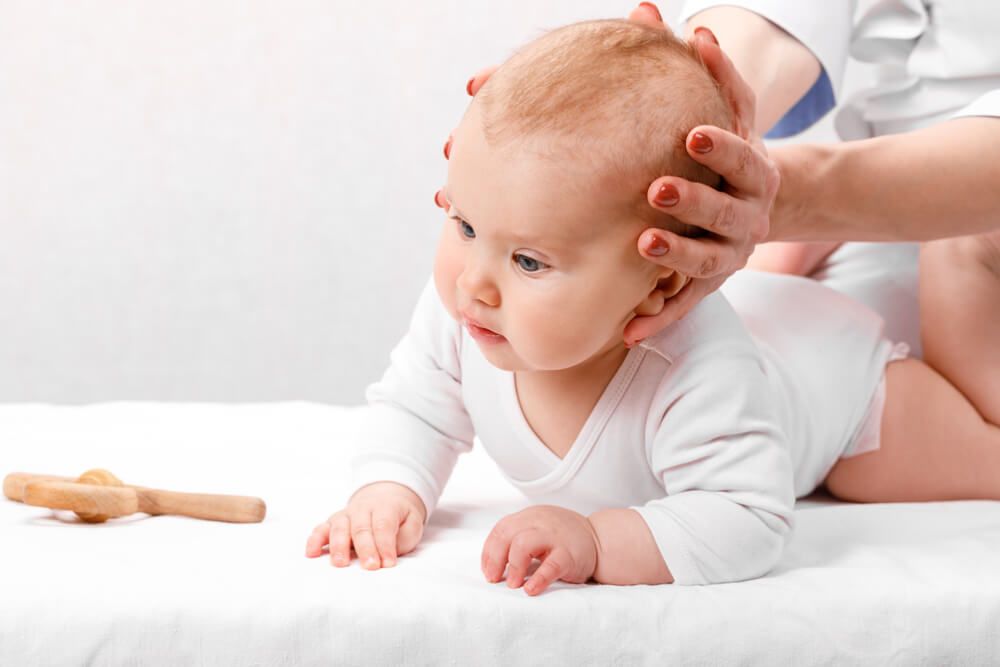 baby girl receiving osteopathic treatment in pediatric clinic