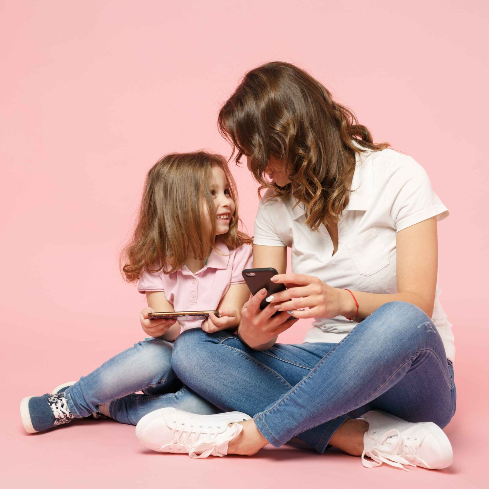 Woman in light clothes have fun with cute child baby