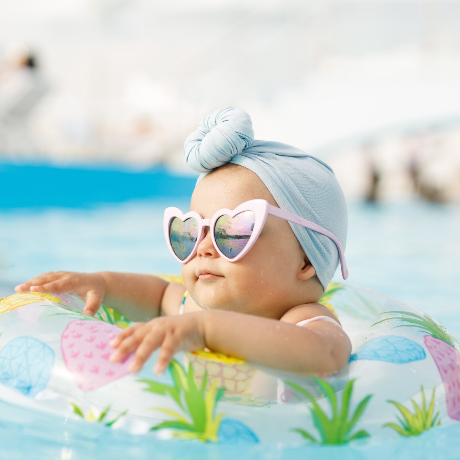 Cute funny toddler girl relaxing on inflatable toy ring